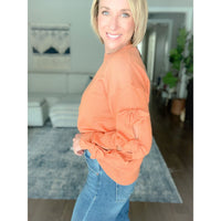 Women's boutique bow sweater burnt orange side