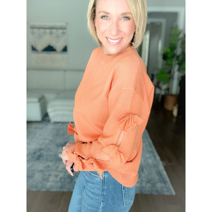 Women's boutique bow sweater burnt orange detail