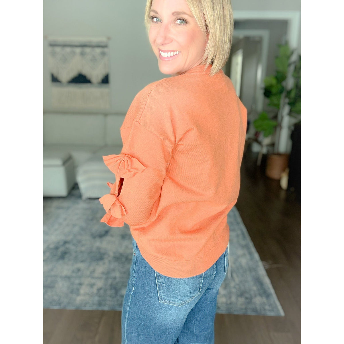 Women's boutique bow sweater burnt orange back